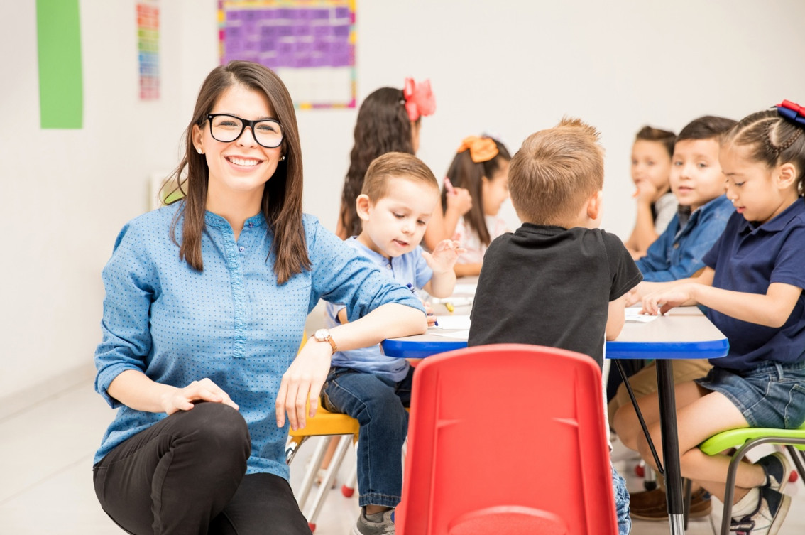 Australian teacher aide supervising a classroom.