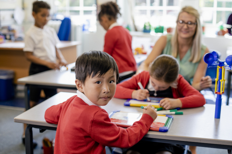 Australian teacher aide supervising a classroom.