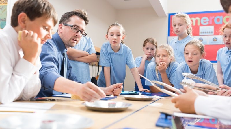 Teacher engaging students with an art activity.