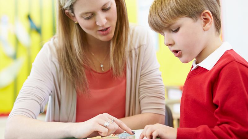 Learning support officer working one-on-one with a student.