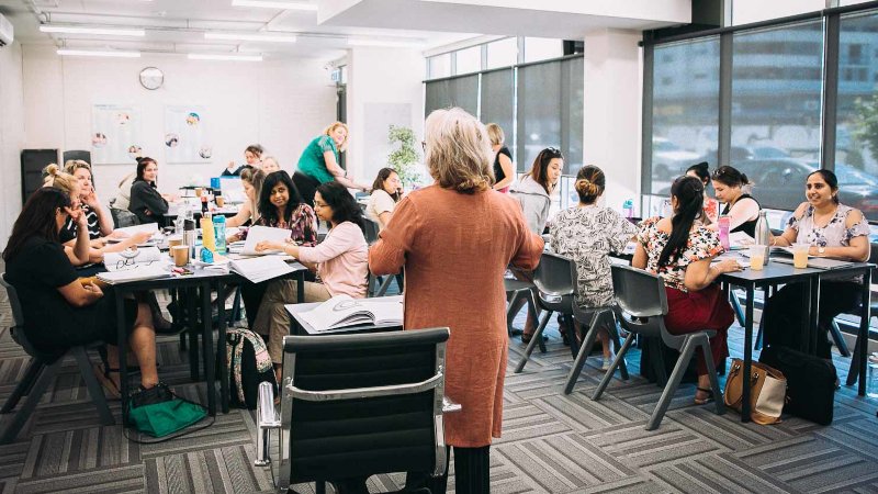 Group of adults and trainer learning the skills to become a teacher aide