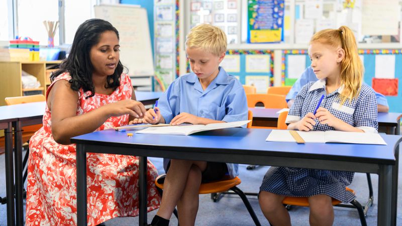 Teacher assistant pictured applying best practice techniques.