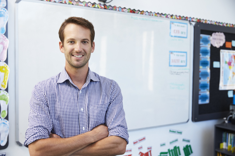 Male classroom teacher infront of whiteboard.