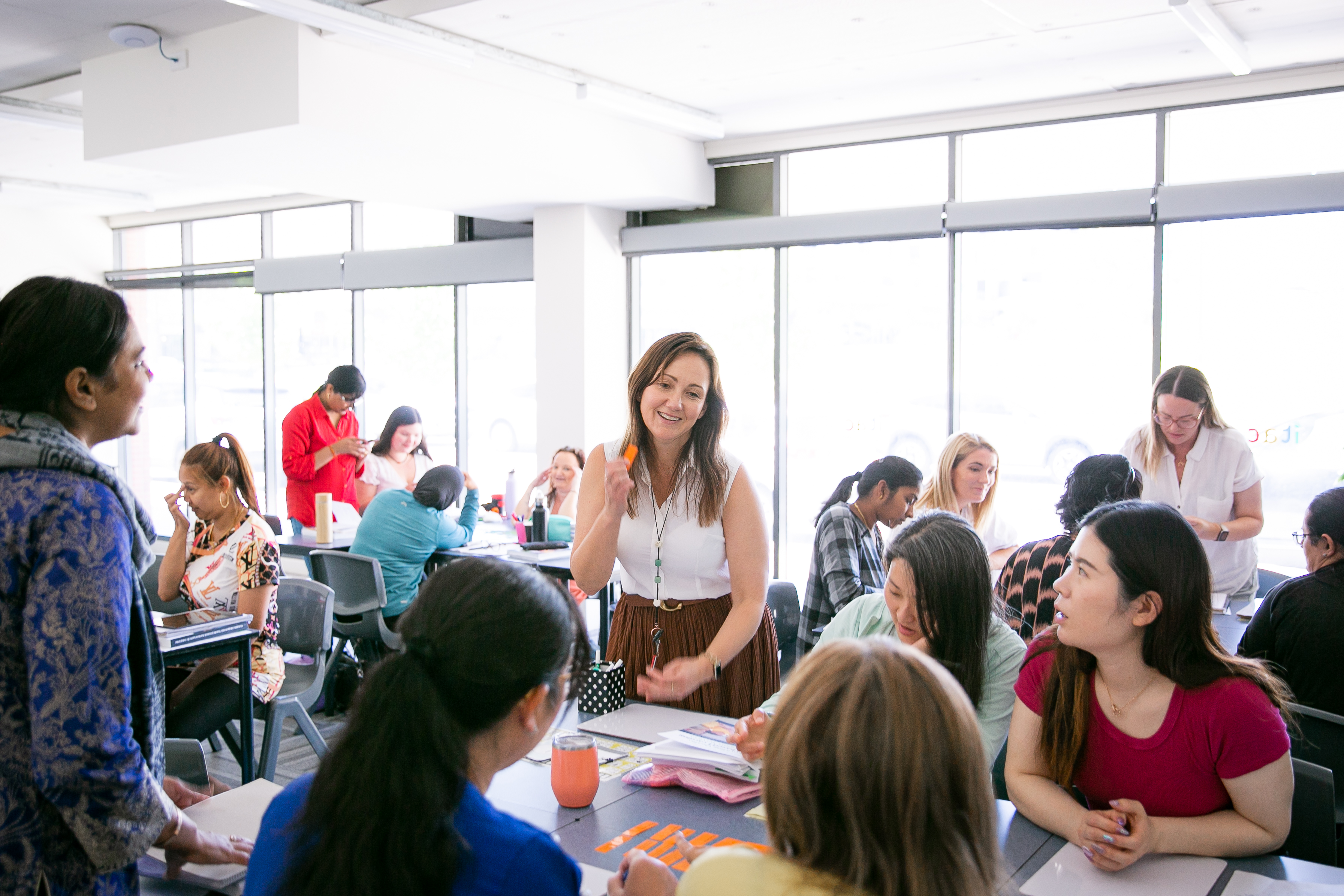 ITAC students and teacher in class in small groups.